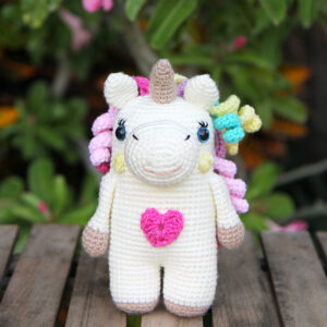 Crochet unicorn with a heart on his belly