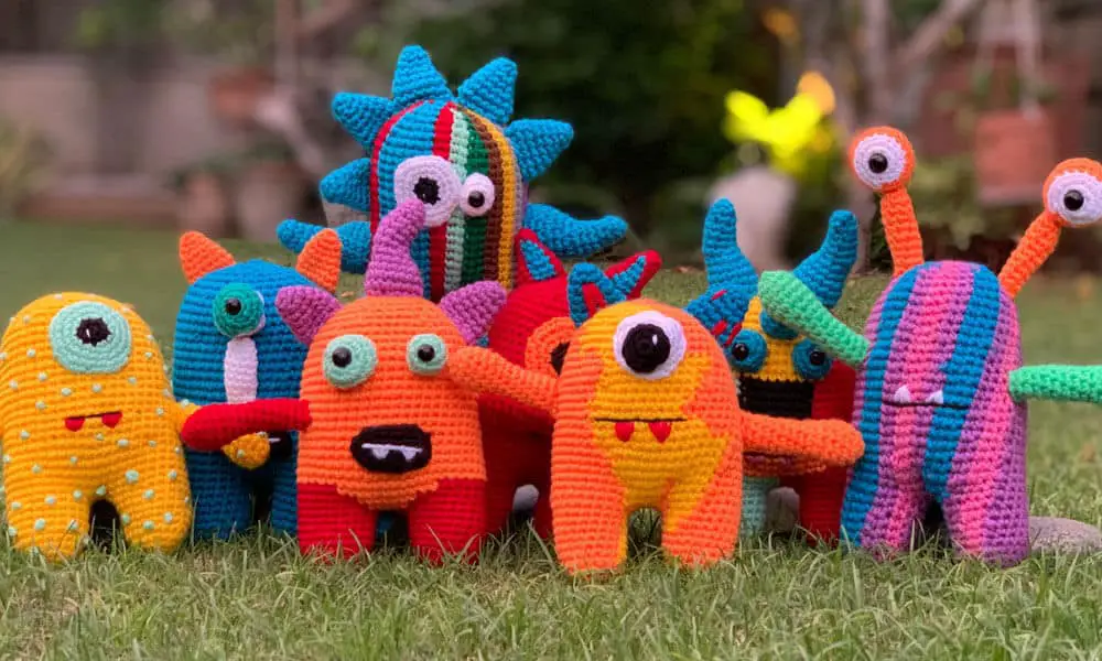 A group of mix and match crochet monsters designed by kids and crocheted using this free pattern and printable