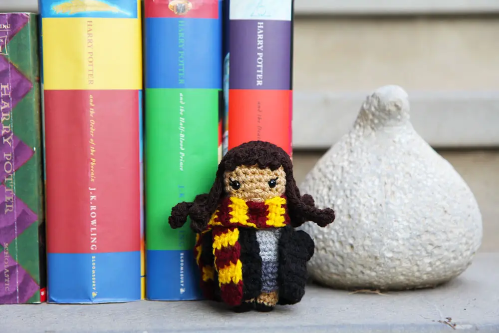 mini hermione granger crochet doll standing in front of harry potter books
