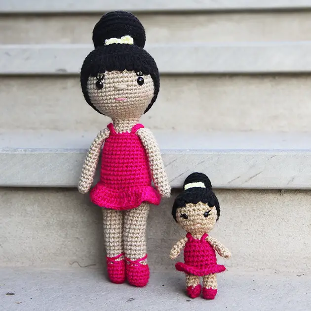 A large amigurumi ballerina doll with a mini ballerina crochet doll