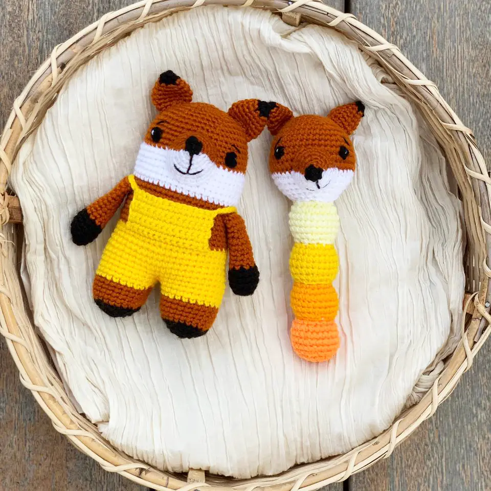 crochet fox toy with a matching crochet fox rattle