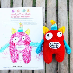 Red amigurumi monster with a drawing of the same monster