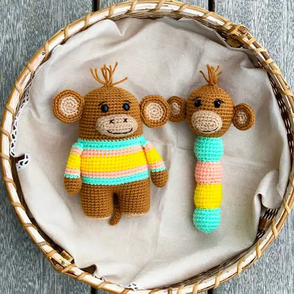 Crochet monkey toy and baby rattle in a basket