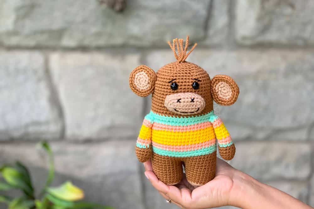Crochet monkey in a striped sweater