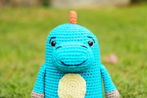blue crochet dinosaur with a close up on the muzzle