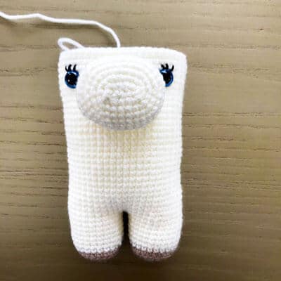 crochet unicorn body half complete with muzzle and eyes inserted