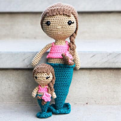 A large amigurumi mermaid doll with a small crochet mermaid doll