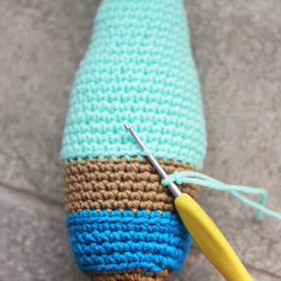 crochet hook inserted into back loops to mermaid tail top