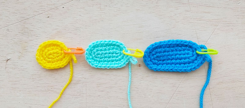 three crochet ovals of different sizes