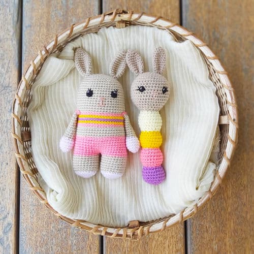 a crochet bunny toy and a matching crochet rabbit baby rattle in a basket