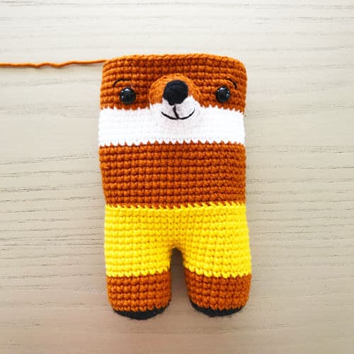 incomplete crochet fox with the muzzle and eyes inserted