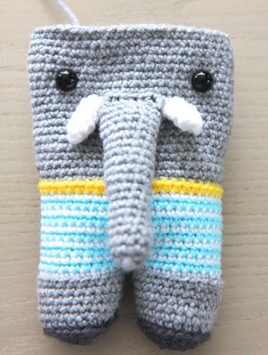 incomplete crochet elephant with eyes tusks and trunk added