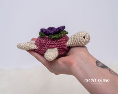 crochet turtle with a flower on its shell