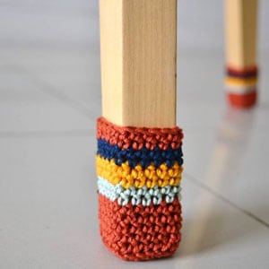 crochet chair socks in orange, gray, yellow, and blue