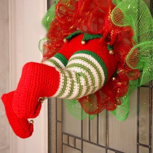 crochet Christmas wreath with an elf's legs sticking out