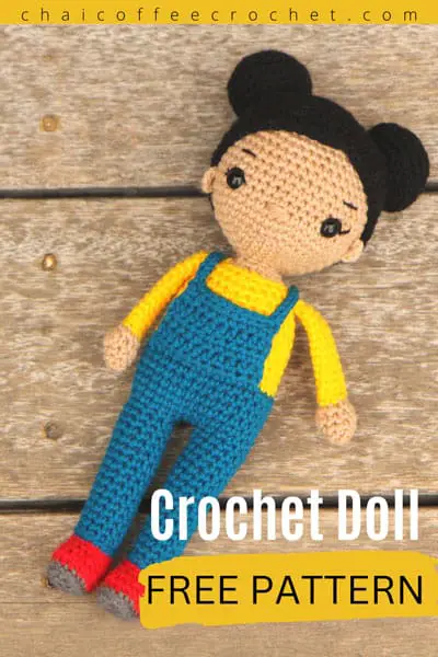 crochet doll with overalls and hair buns