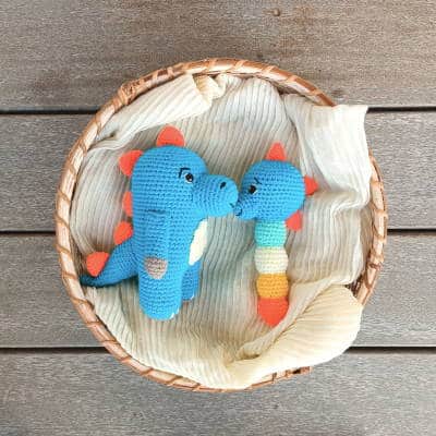 crochet blue dinosaur with a matching baby rattle