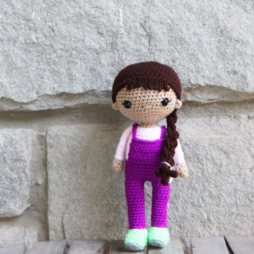 Crochet doll with overalls and a side braid