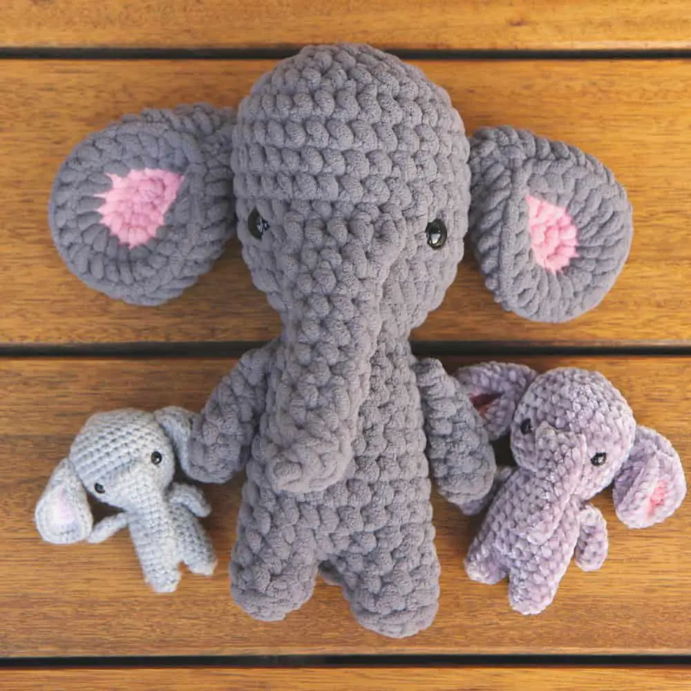 three crochet elephants. The first is a small one with DK yarn. The second elephant is signficiantly larger in blanket yarn. And the third elephant is medium sized in chenille yarn