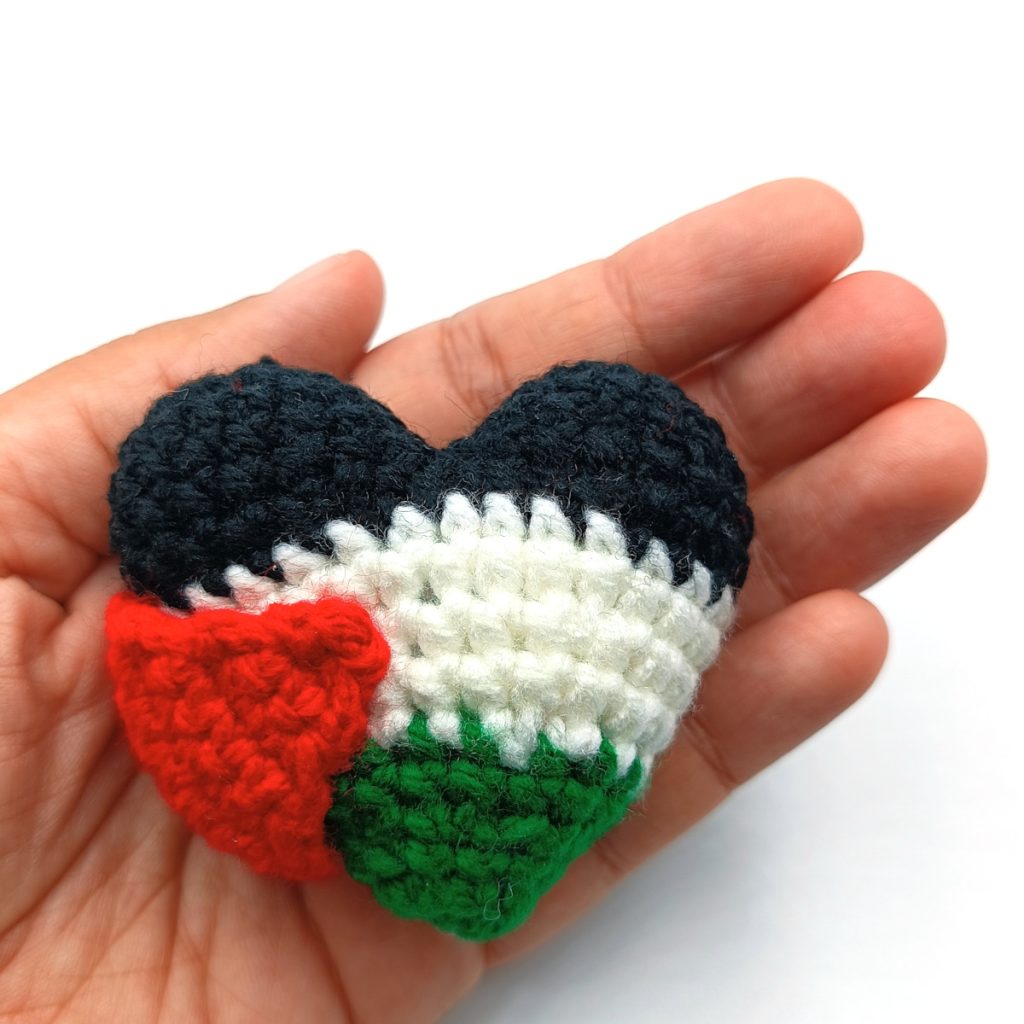 Palestine crochet flag heart held in a hand