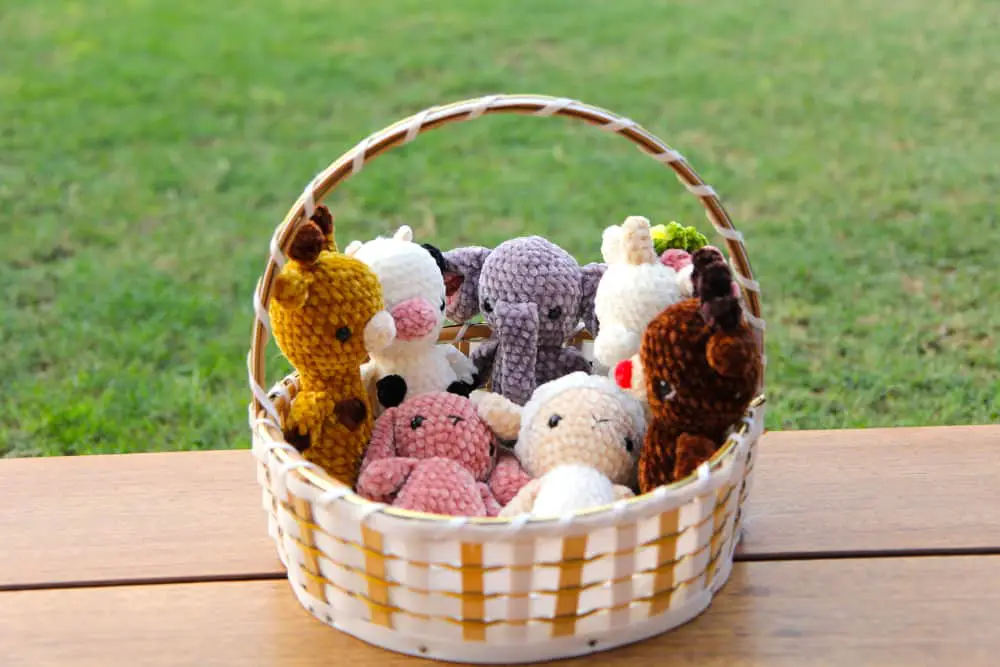 small crochet animals in velvet yarn in a basket