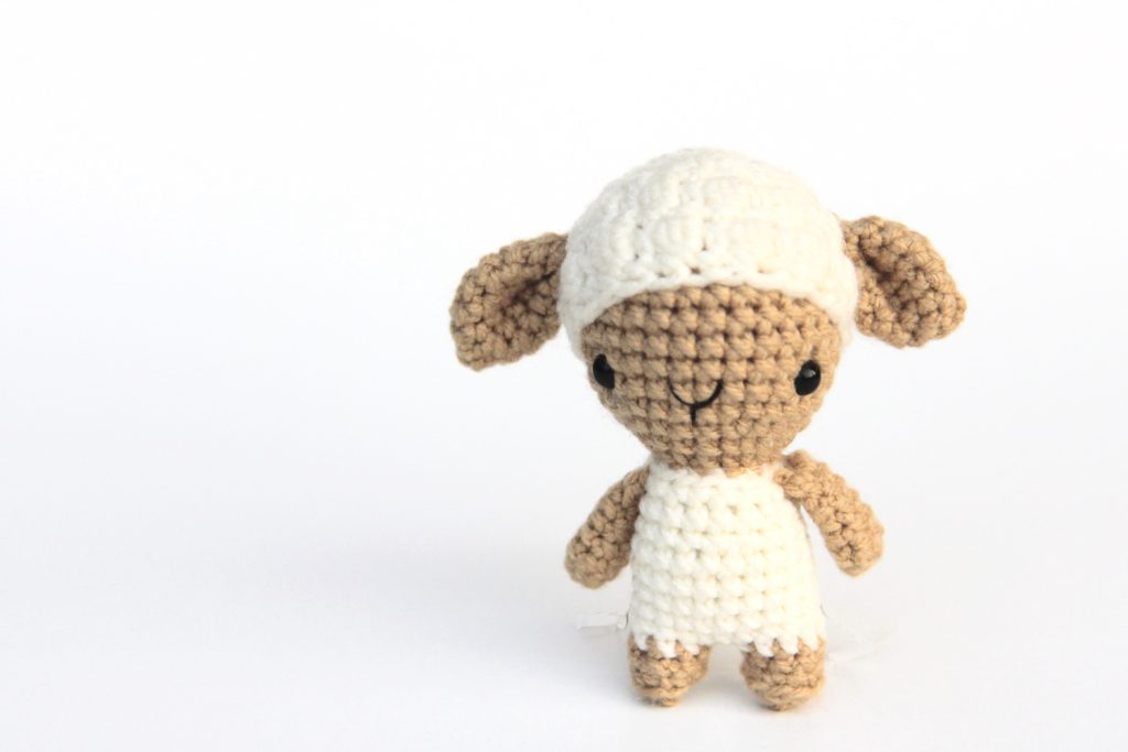 small crochet sheep with a fluffy hair cap