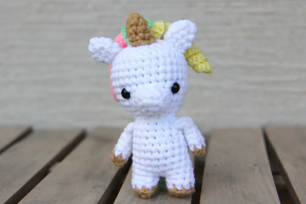 small crochet unicorn with a curly mane