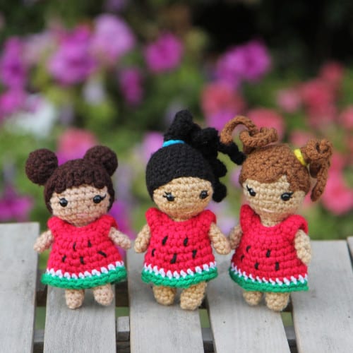 3 summer crochet dolls with different hairstyles in watermelon dresses