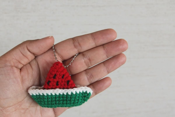 crochet boat keychain in the colours of a watermelon