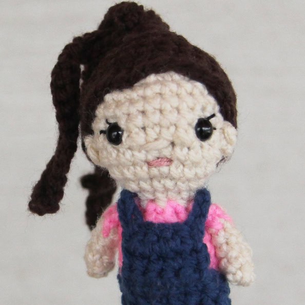 crochet doll with a ponytail and overalls