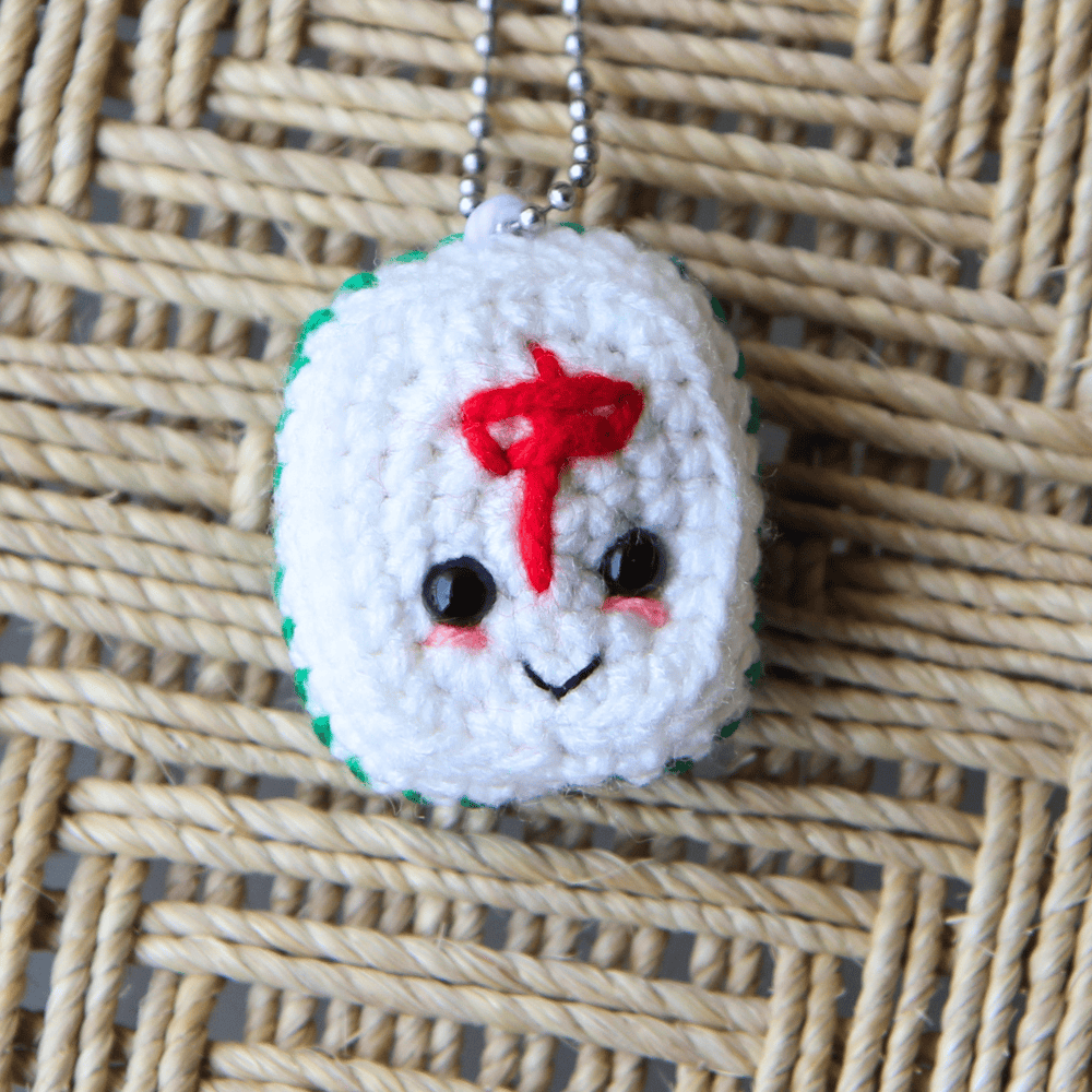 cute kawaii mahjong crochet tile with eyes and a mouth
