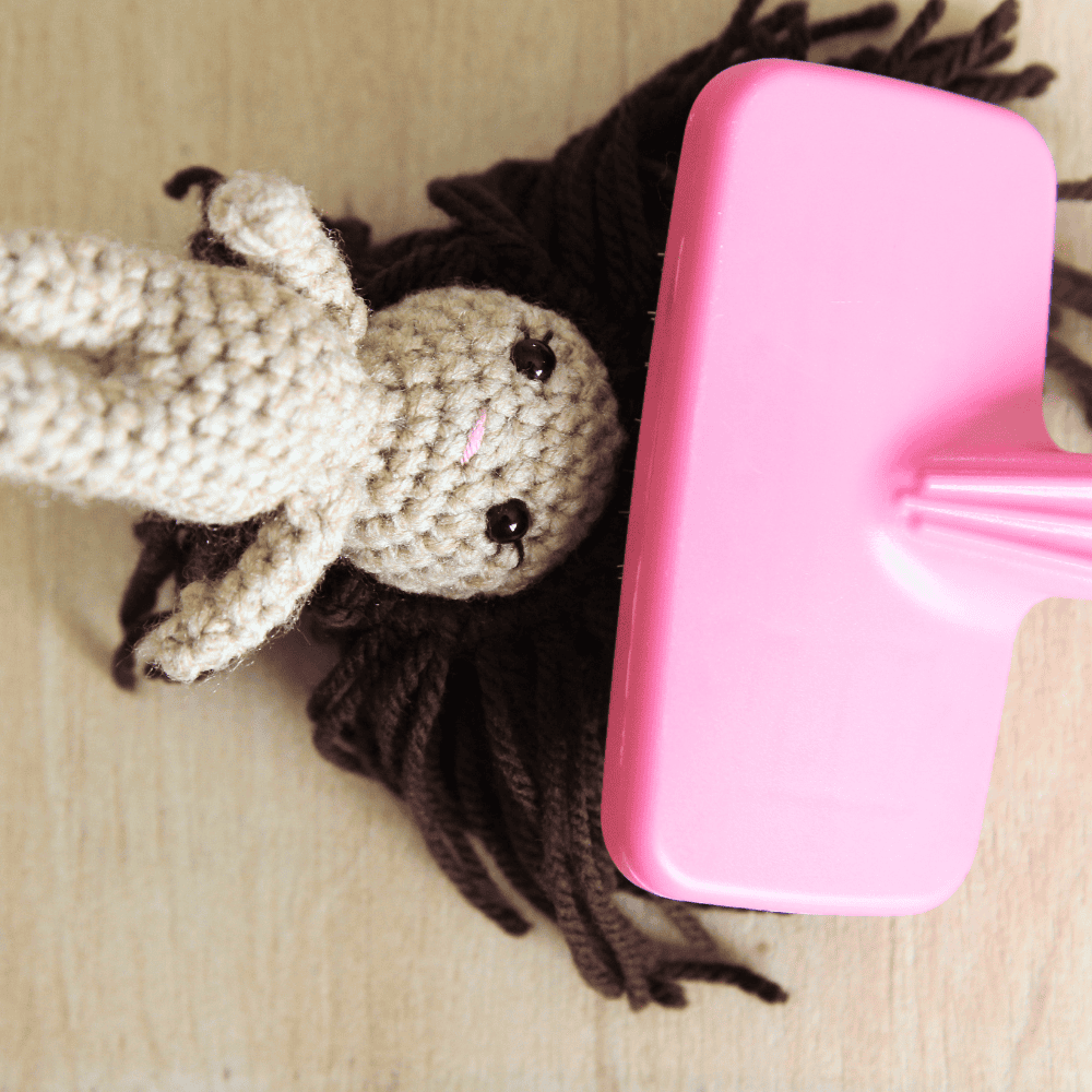 doll hair being brushed using a pet slicker brush